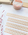 Premium Handmade Washi Tape Warm Heart 15mm x 10m - 4 pieces and 2 washi tapes on the table with a dark maroon flower branch, a sticker sheet, a notebook