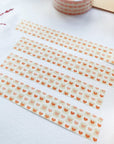 Premium Handmade Washi Tape Warm Heart 15mm x 10m - 4 pieces and 2 washi tapes on the table with a dark maroon flower branch