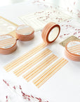 Premium Handmade Washi Tape Warm Line 15mm x 10m - 4 pieces and 4 washi tapes on the table with 2 dark maroon flower branches, a sticker sheet, a chapter heading