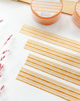 Premium Handmade Washi Tape Warm Line 15mm x 10m - 4 pieces and 2 washi tapes on the table with a dark maroon flower branch