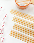 Premium Handmade Washi Tape Warm Line 15mm x 10m - 4 pieces and 2 washi tapes on the table with a dark maroon flower branch