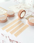 Premium Handmade Washi Tape Warm Line 15mm x 10m - 4 pieces and 4 washi tapes on the table with 2 dark maroon flower branches, a sticker sheet, a chapter heading, a notebook