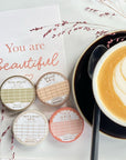 Premium Handmade Washi Tape White & Brown Grid 15mm x 10m - 4 washi tapes on the table with a dark pink flower branch, a cup of latte, a spoon