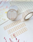 Premium Handmade Washi Tape White & Brown Grid 15mm x 10m - 3 pieces and 3 washi tapes on the table with 2 dark pink flower branches, a chapter heading, a sticker sheet