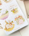 Premium Handmade Sticker Sheet A Day At Home 105mm x 148mm - a sheet on the table with an opened notebook