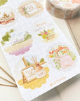 Premium Handmade Sticker Sheet A Day At Home 105mm x 148mm - a sheet on the table with a white flower branch, a washi tape, an opened notebook