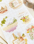 Premium Handmade Sticker Sheet A Day At Home 105mm x 148mm - a sheet on the table with a washi tape, an opened notebook