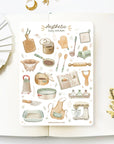 Premium Handmade Sticker Sheet Aesthetic Cozy Kitchen 105mm x 148mm - a sheet on the table with a white flower branch, an opened notebook