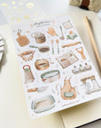 Premium Handmade Sticker Sheet Aesthetic Cozy Kitchen 105mm x 148mm - a sheet on the table with a pencil, an opened notebook