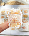 Premium Handmade Sticker Sheet Autumn in my Heart 105mm x 148mm - a piece on hand and a sheet on the table with an opened notebook