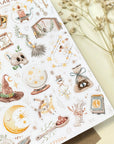 Premium Handmade Sticker Sheet Dark Magic 105mm x 148mm - a sheet on the table with a white flower branch
