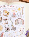 Premium Handmade Sticker Sheet Dark Magic 105mm x 148mm - a sheet on the table with a purple flower branch, an opened notebook
