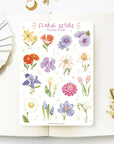 Premium Handmade Sticker Sheet Floral Desire 105mm x 148mm - a sheet on the table with a white flower branch, an opened notebook