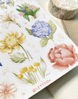 Premium Handmade Sticker Sheet Floral Power 105mm x 148mm - a sheet on the table with a washi tape, an opened notebook