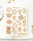 Premium Handmade Sticker Sheet Romantic Flower 105mm x 148mm - a sheet on the table with a white flower branch, an opened notebook