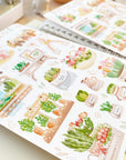 Premium Handmade Sticker Sheet Spring Garden 105mm x 148mm - 2 sheets on the table with an opened notebook