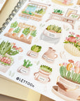 Premium Handmade Sticker Sheet Spring Garden 105mm x 148mm - a sheet on the table with an opened notebook
