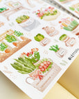 Premium Handmade Sticker Sheet Spring Garden 105mm x 148mm - 2 sheets on the table with an opened notebook