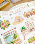 Premium Handmade Sticker Sheet Spring Garden 105mm x 148mm - a sheet on the table with an opened notebook