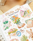Premium Handmade Sticker Sheet Spring Vibes 105mm x 148mm - a sheet on the table with an opened notebook