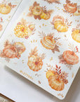 Premium Handmade Sticker Sheet Sweet Pumpkin 105mm x 148mm - 2 sheets on the table with an opened notebook