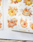 Premium Handmade Sticker Sheet Sweet Pumpkin 105mm x 148mm - 2 sheets on the table with an opened notebook