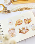 Premium Handmade Sticker Sheet Sweet Pumpkin 105mm x 148mm - 6 pieces on a handbook on the table with an opened notebook