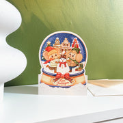 Snowy Amsterdam Christmas card, Dutch front, styled on a shelf with its envelope