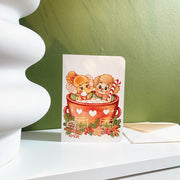 Hot Cacao Christmas card, styled on a shelf with its envelope