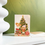 Decorating Tree Christmas card, styled on a shelf with its envelope