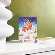 In Case We Don't Stop Christmas card, English front, styled on a shelf with its envelope