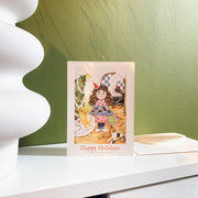 Everything Under Control Christmas card, English front, styled on a shelf with its envelope
