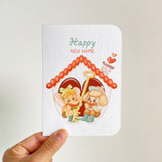 Happy New Home — greeting card held in hand
