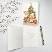 Decorating Tree Christmas card opened, with the blank inside and a pen