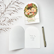 Holiday Wreath Christmas card opened, English front with the blank inside and a pen