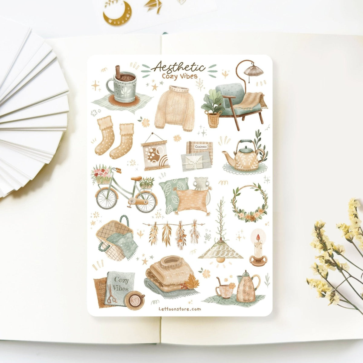 Premium Handmade Sticker Sheet 
Aesthetic Cozy 105mm x 148mm - a sheet on the table with a white flower branch, an opened notebook