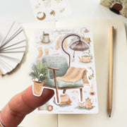 Premium Handmade Sticker Sheet 
Aesthetic Cozy 105mm x 148mm - a piece on the finger and a sheet on the table with a pencil, an opened notebook
