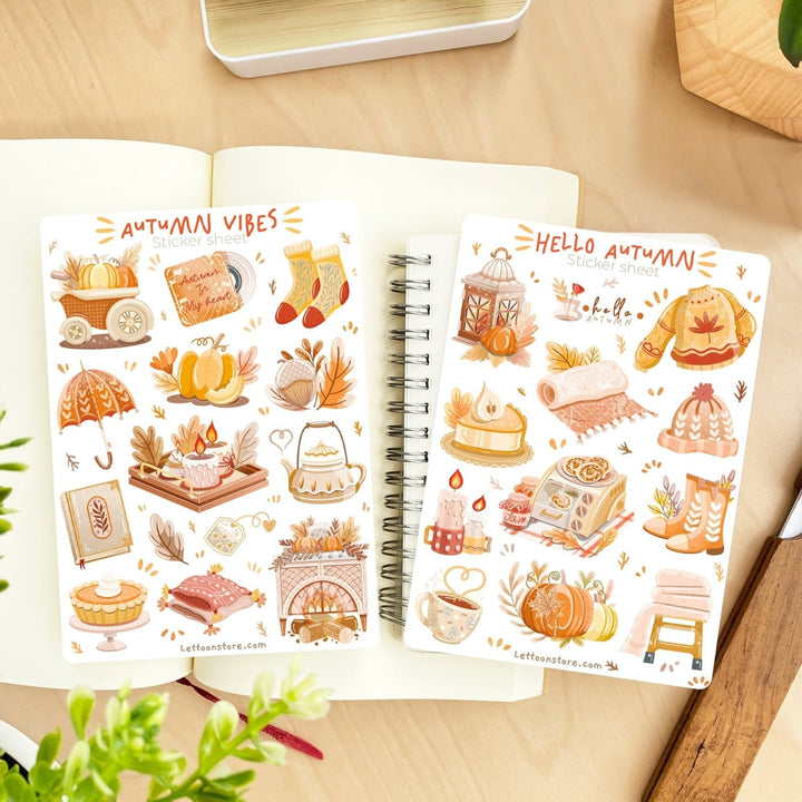 Premium Handmade Sticker Sheet Autumn in my Heart 105mm x 148mm - 2 sheets on the table with a plant branch, an opened notebook