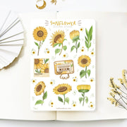 Premium Handmade Sticker Sheet Chamomile Sunflower 105mm x 148mm - a sheet on the table with a white flower branch, an opened notebook