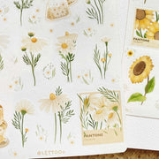 Premium Handmade Sticker Sheet Chamomile Sunflower 105mm x 148mm - a sheet on the table with an opened notebook