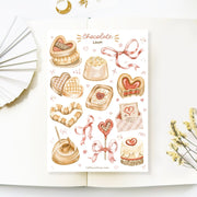 Premium Handmade Sticker Sheet 
Chocolate Lover 105mm x 148mm - a sheet on the table with a white flower branch, an opened notebook