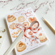 Premium Handmade Sticker Sheet 
Chocolate Lover 105mm x 148mm - a piece and a sheet on the table with a dark maroon flower branch, a pencil in the background