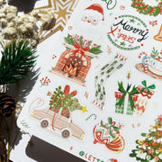 Premium Handmade Sticker Sheet Christmas 105mm x 148mm - a sheet on the table with a white flower branch, an opened notebook, a pinecone, a pine branch