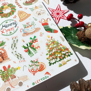 Premium Handmade Sticker Sheet Christmas 105mm x 148mm - a sheet on the table with an opened notebook, 2 pinecones, a red berry branch, a star