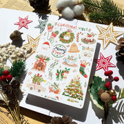 Premium Handmade Sticker Sheet Christmas 105mm x 148mm - a sheet on the table with a white flower branch, an opened notebook, 3 pinecones, 2 pine branches, 2 red berry branches, 5 stars