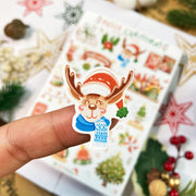 Premium Handmade Sticker Sheet Christmas 105mm x 148mm - a piece and a sheet on the table with an opened notebook, an acorn, 5 stars