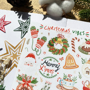 Premium Handmade Sticker Sheet Christmas 105mm x 148mm - a sheet on the table with a white flower branch, an opened notebook, a pinecone, 3 stars