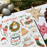 Premium Handmade Sticker Sheet Christmas 105mm x 148mm - a sheet on the table with an opened notebook, a pinecone, 2 stars