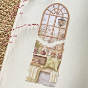 Premium Handmade Sticker Sheet Cozy Corner 105mm x 148mm - 2 pieces on the table with a pink flower branch