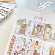 Premium Handmade Sticker Sheet Cozy Doors 105mm x 148mm - a sheet on the table 